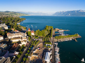 High angle view of townscape by sea against sky