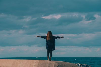 Man standing by sea against sky