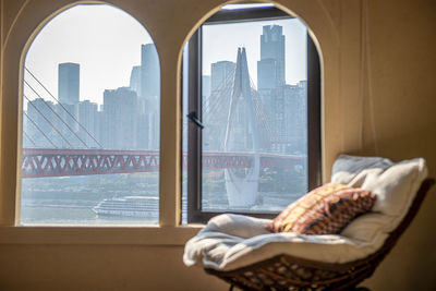 Rear view of woman looking through window