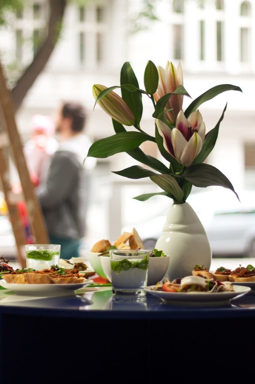 freshness, indoors, table, flower, food and drink, plate, vase, close-up, still life, focus on foreground, food, leaf, white color, ready-to-eat, fragility, decoration, potted plant, restaurant, plant, healthy eating