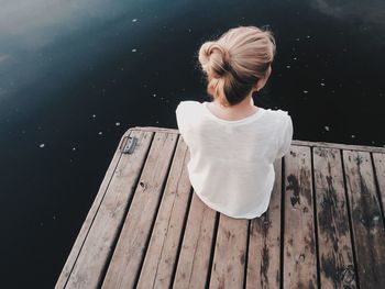 Rear view of woman overlooking calm lake