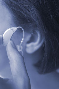 Close-up of woman with hearing aid