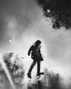 Reflection of people in puddle