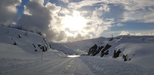 Scenic view of snow covered mountains against sky