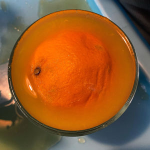 High angle view of orange juice in glass on table