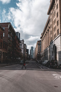 View of city street and buildings against sky