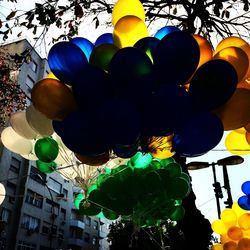 Low angle view of multi colored balloons