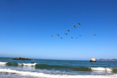 Scenic view of sea against clear blue sky