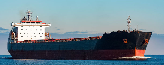 Commercial dock by sea against sky