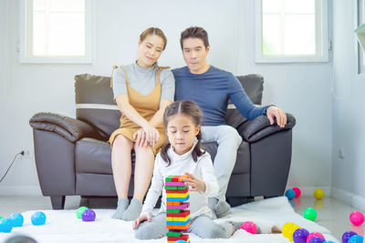 Father and son sitting on sofa at home