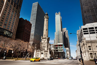 View of city street and buildings against sky