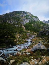 Scenic view of waterfall against sky