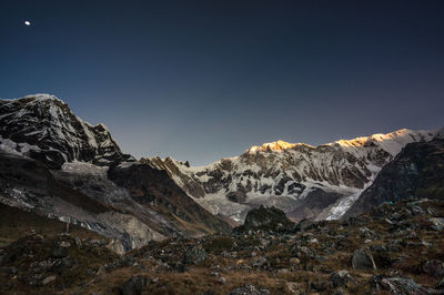 Scenic view of snowcapped mountains against clear sky