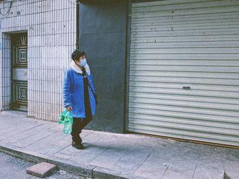 Full length of woman walking on footpath