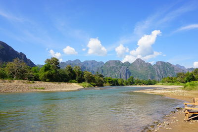 Scenic view of sea and mountains against sky