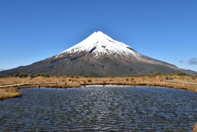 Scenic view of snowcapped mountains against clear blue sky