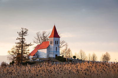 Traditional building on field against sky