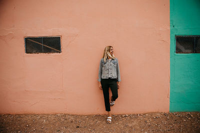 Woman standing against wall