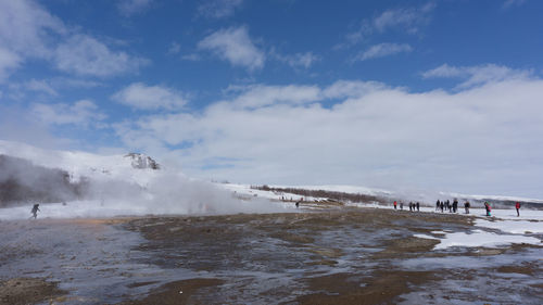 View of snowcapped landscape against cloudy sky