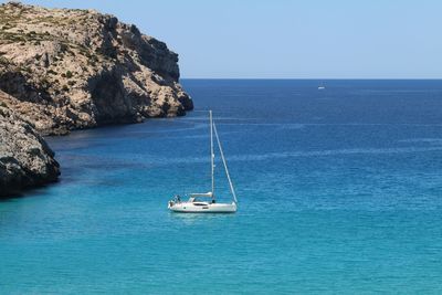 Sailboat sailing in sea against sky