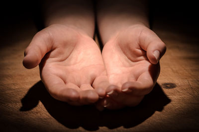 Close-up of baby hands on table