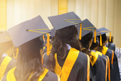 Rear view of women in graduation during ceremony