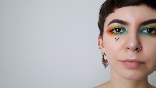 Portrait of beautiful woman against white background