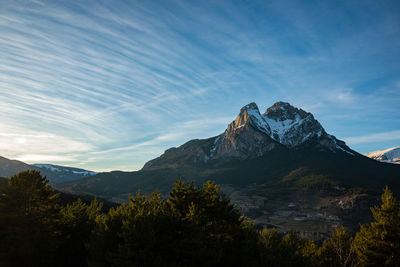 Scenic view of mountains against blue sky