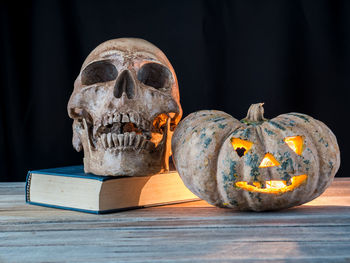 Close-up of human skull on wooden table