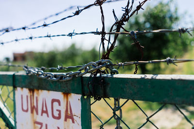 Close-up of barbed wire on fence