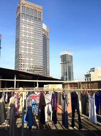 Clothes for sale against tall buildings