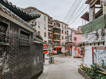 Street amidst buildings in city against sky