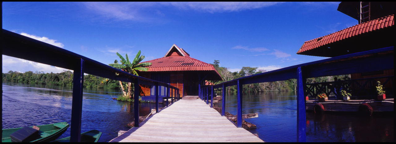 BUILDING BY LAKE AGAINST SKY