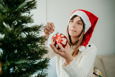 Portrait of woman with christmas tree