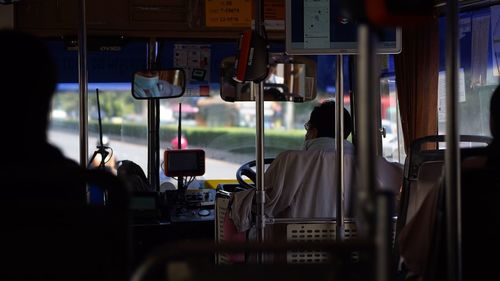 Rear view of driver driving vehicle