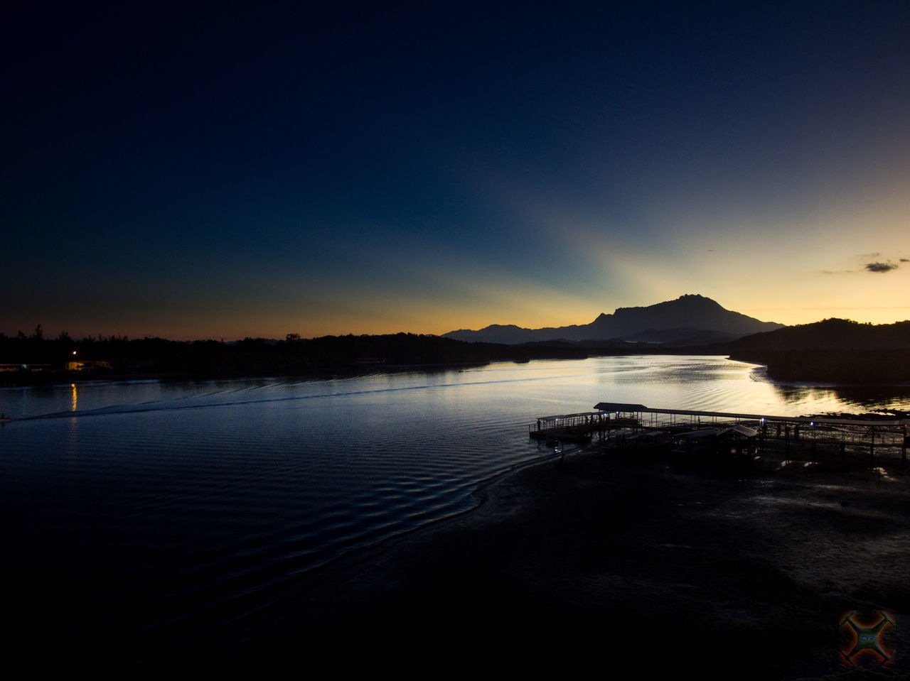 SCENIC VIEW OF LAKE AGAINST SKY AT SUNSET