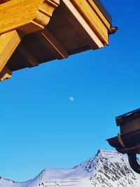 Low angle view of buildings against clear blue sky