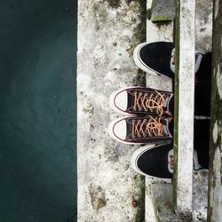 Overhead view of feet on bridge