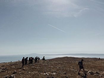 People on beach against sky