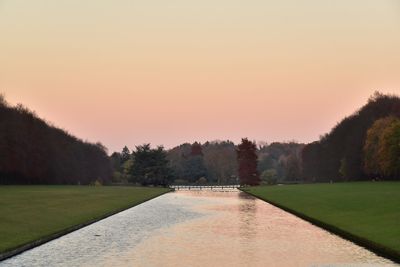 Scenic view of park against clear sky during sunset