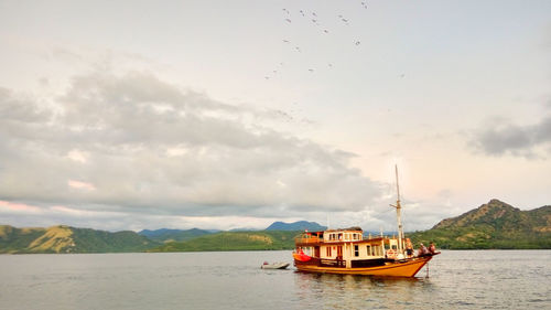Boat in river against sky