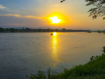 Scenic view of lake against sky during sunset