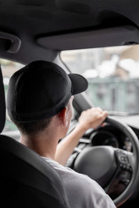 A young guy driving a car.