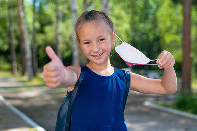 Portrait of smiling girl standing outdoors