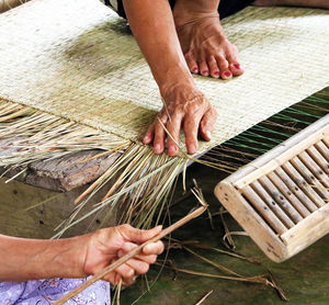 Traditional weaving of a carpet by hand in a vietnamese village.