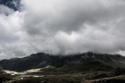 Scenic view of mountains against cloudy sky