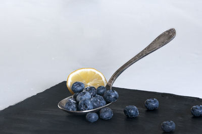 Close-up of fruits on table against white background