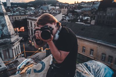 Woman photographing at camera