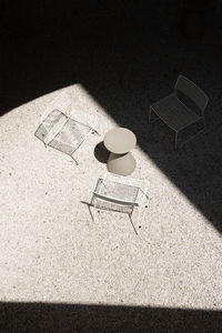 High angle view of empty chair on table