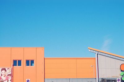 Low angle view of building against clear blue sky